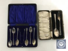 A set of six cased sterling silver teaspoons with sugar tongs and a cased silver fork and spoon