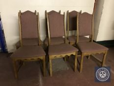 A set of six blonde oak high backed dining chairs upholstered in purple fabric