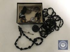 A box of assorted jewellery including Whitby Jet necklace and brooch, cross pendant,