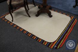 A hand tufted contemporary rug with multi coloured border,