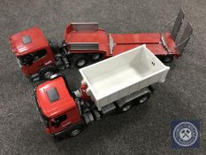 A large scale Bruder tipper truck and a Bruder truck with flat bed trailer