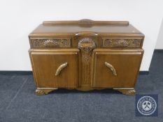 An early 20th century carved oak sideboard