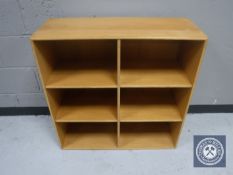 A set of blonde oak cube shelves