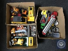 Three boxes of plastic vehicles including fork lift truck, tanker,