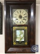 An early 20th century American cased wall clock with pendulum and weights