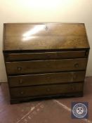 A late nineteenth century oak bureau fitted with four drawers