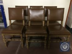 A set of six twentieth century oak dining chairs upholstered in buttoned leather