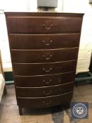 A mid twentieth century teak bow fronted seven drawer chest