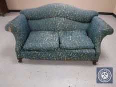 An early 20th century scroll arm settee on claw and ball feet