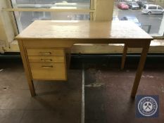 A mid twentieth century single pedestal desk fitted with three drawers