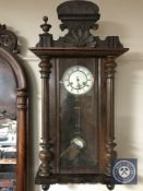 A 20th century Junghans Vienna style wall clock with pendulum and key