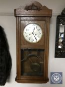 A 20th century oak wall clock with silvered dial,