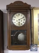 A 20th century oak wall clock with silvered dial,