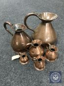 A graduated set of six copper jugs
