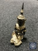 A bronze and mixed metal seated deity figure