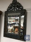 A 20th century metal framed cushion mirror