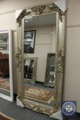 A champagne coloured leaning mirror,