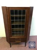 A mid 20th century leaded door corner cabinet