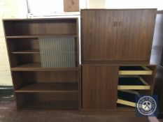 A mid twentieth century teak double door storage cabinet together with a sliding door bookshelf