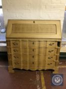 A blonde oak writing bureau