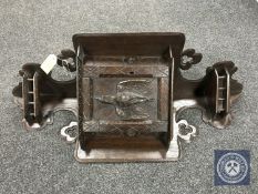 A 19th century oak corner wall cabinet with carved door depicting dead game