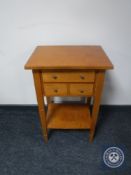 A contemporary side table fitted with three drawers with undershelf