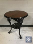 A circular Britannia pub table on cast iron base