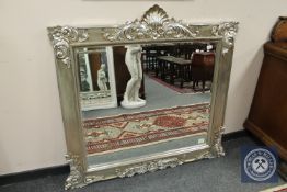 A champagne coloured over mantel mirror,