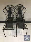 A set of four wrought iron dining chairs