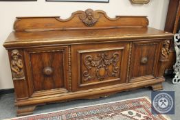 A continental carved oak sideboard,