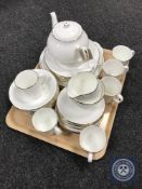 A tray of clock under shade, brass ornaments, decanter,