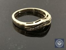 A 9ct gold diamond ring, fourteen brilliant-cut diamonds within a serpentine channel setting,