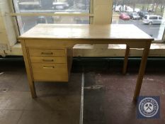 A mid twentieth century single pedestal desk fitted with three drawers