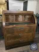 A late nineteenth century inlaid mahogany barrel fronted bureau