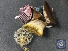 A brass light fitting with glass drops, box of throw, two tapestry cushions,