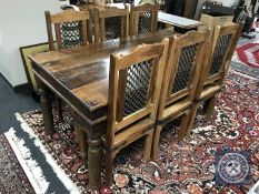 An Eastern style hardwood dining table with six chairs