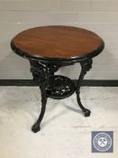 A circular Britannia pub table on cast iron base