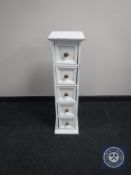 A painted narrow pine five drawer chest