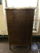 A mid twentieth century walnut six drawer chest