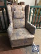 A twentieth century wing backed armchair