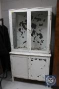 A mid 20th century metal glazed door medical cabinet,