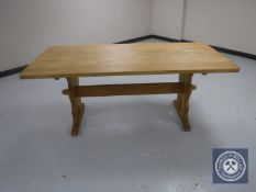 A blonde oak refectory dining table