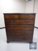 A late George III mahogany six drawer chest on bracket feet