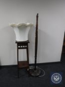 An early twentieth century mahogany plant stand together with standard lamp and shade
