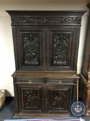 A 19th century continental profusely carved oak cabinet fitted with drawers