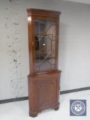 A mahogany corner display cabinet