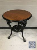 A circular Britannia pub table on cast iron base