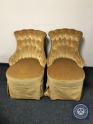 A pair of early 20th century nursing chairs upholstered in golden buttoned dralon