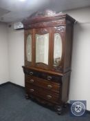 An Edwardian mirror door press fitted with five drawers