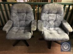 A pair of upholstered swivel armchairs
